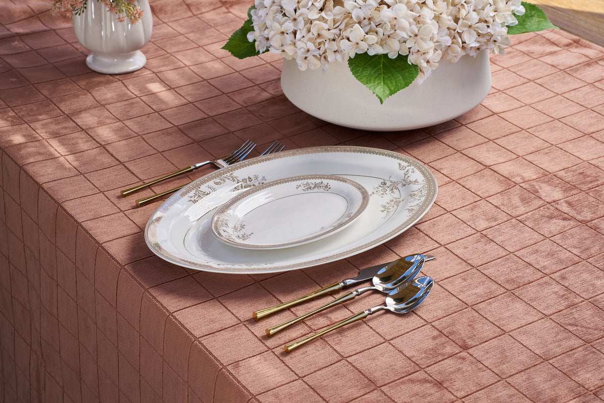 Panama tablecloth in terracotta with gold-and-silver flatware and ivory dinnerware