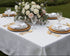 Valence quilted white tablecloth with interlocking fret pattern, set with gold chargers and crystal