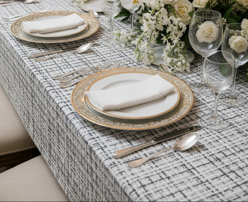 Vincent Boucle Tablecloth in white and black on a set dining table